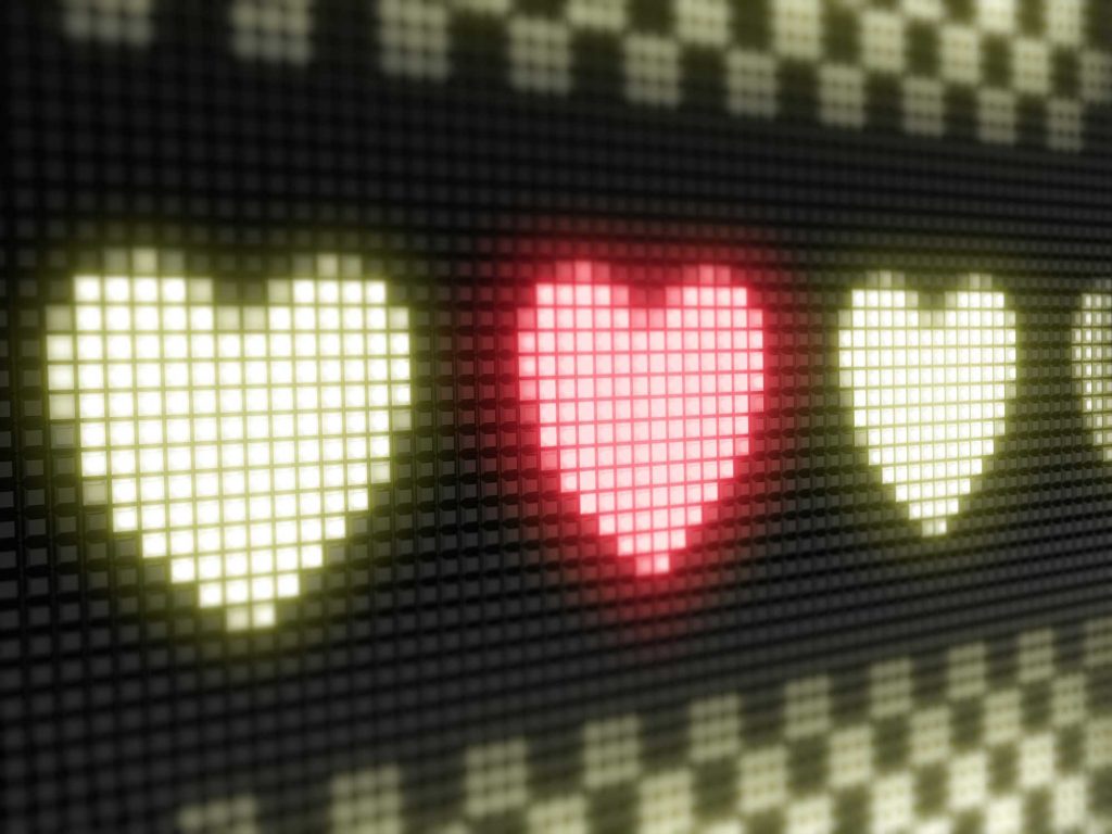 Three hearts displayed on an LED screen