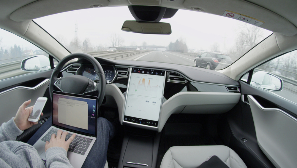Person using devices in autonomous vehicle