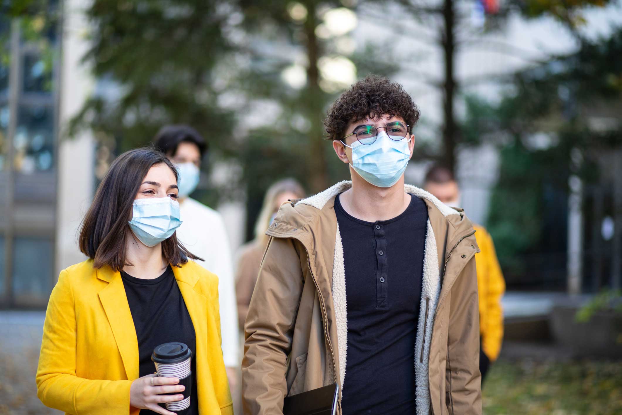 Male and female students wearing masks
