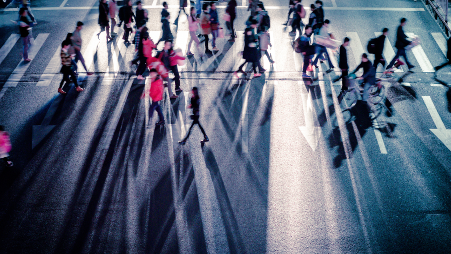 People crossing dark city street