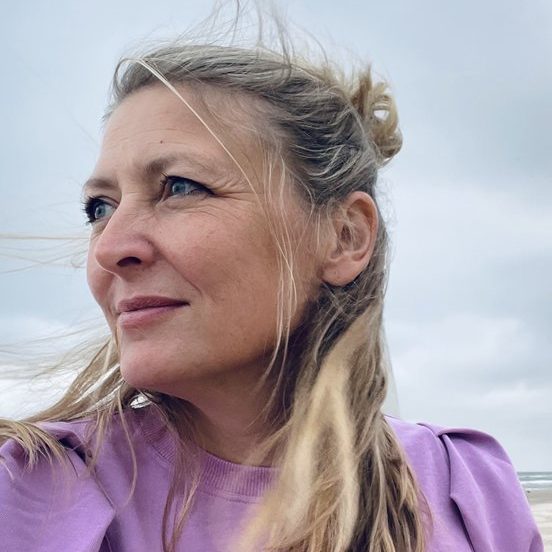 Stephanie_Hankey Photo of Stephanie Hankey. Stephanie has blue eyes and long, blonde hair. She wears a light purple top.