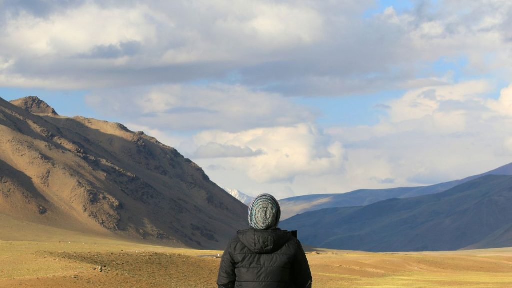 Website - News & Events-2 Person with back towards camera facing mountain range