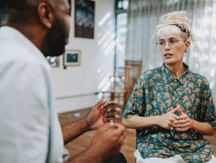 NDIS Two people talking in a therapy session