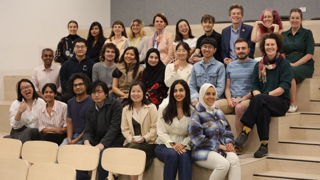 A group of ADM+S members pose on steps