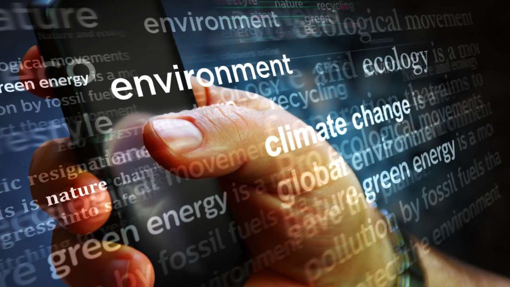 words environment, ecology, green energy overlaid on image of person on phone