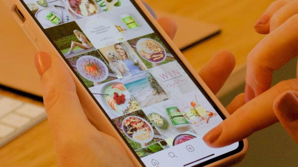 Hands holding smartphone looking at ads