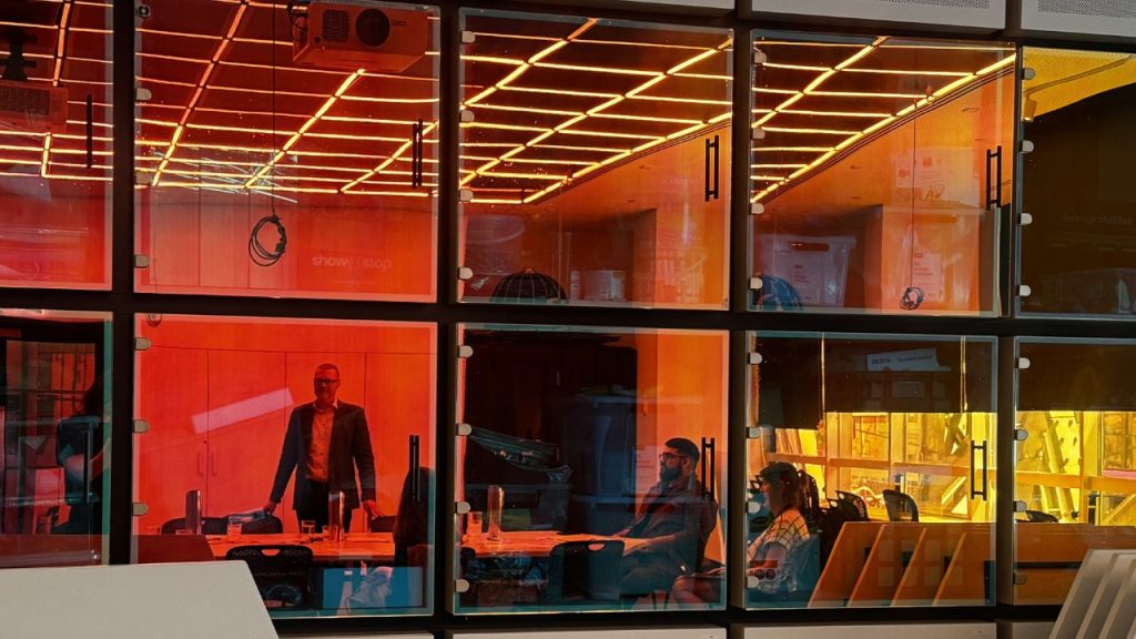 Critical AI Capabilities Index (CAIC Index) Researchers inside buidling with red and orange glass