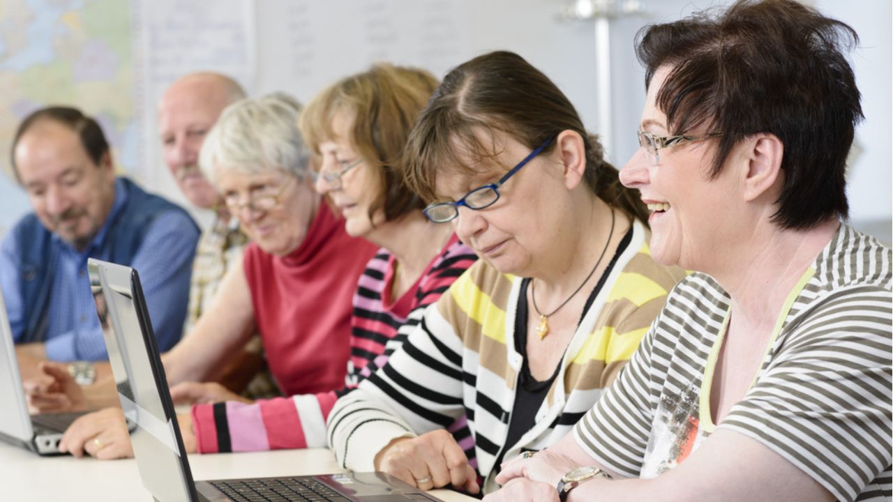 Group of people sitting at laptop