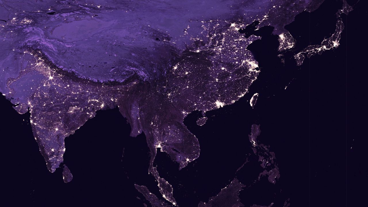 Satellite photo showing city lights showing human activity in India, China, South Korea and Japan from space.